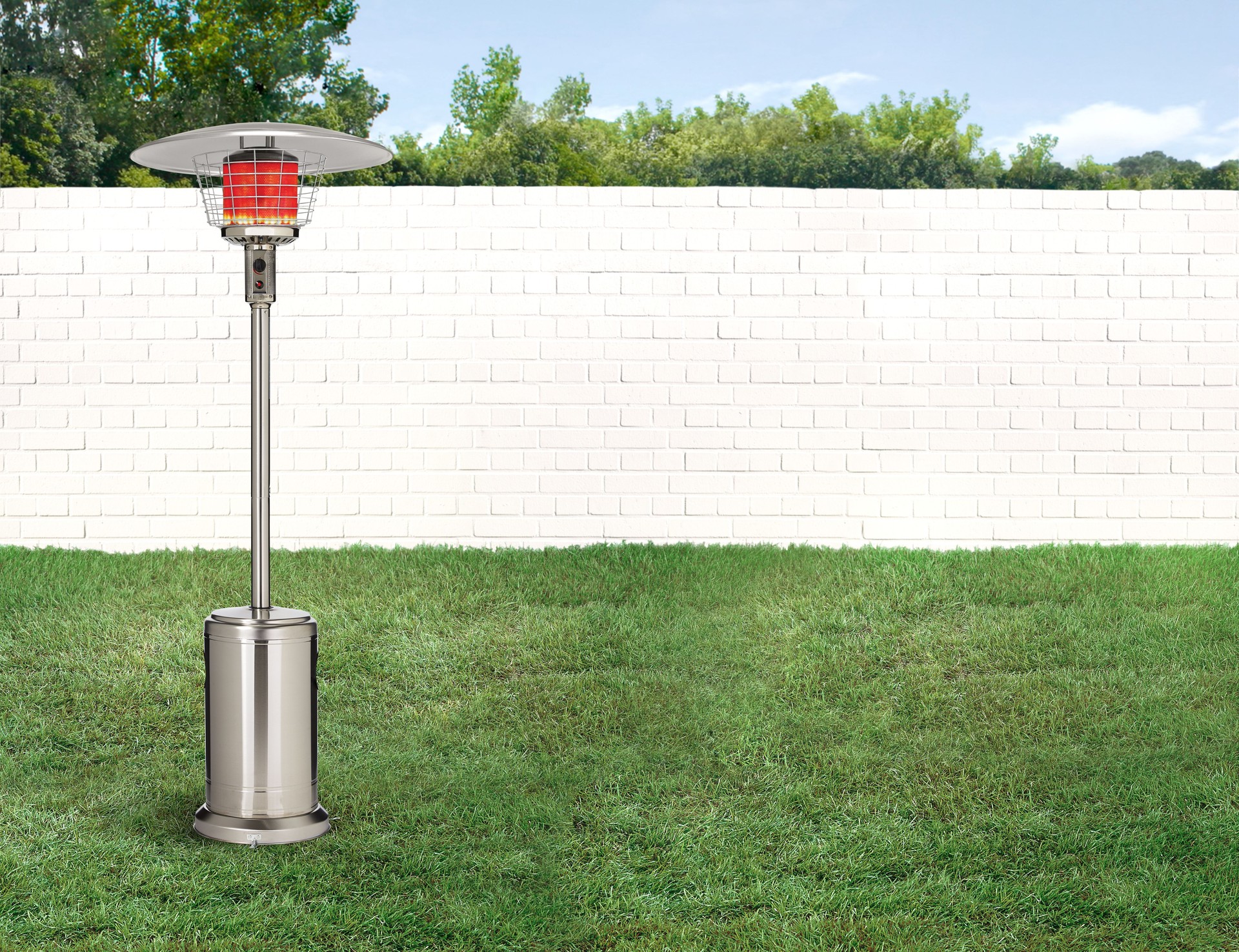 Patio gas heater in a backyard with brick walls