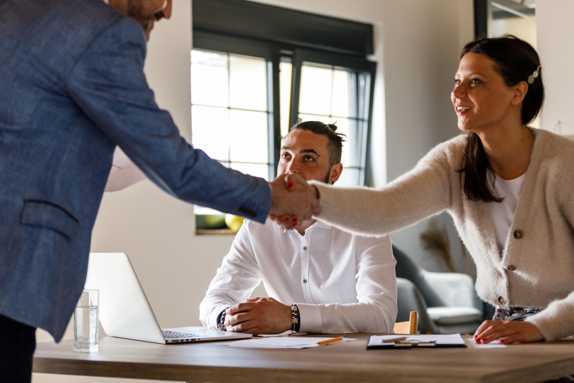 Businessman shaking hands with interviewers at the beginning or after a successful job interview meeting